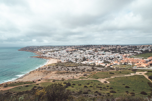View of the city of Luz and the Atlantic Ocean beaches from the top of Atalaia hill in the Algarve region of southern Portugal. Following in the footsteps of the Fisherman Trail. Rota Vicentina.