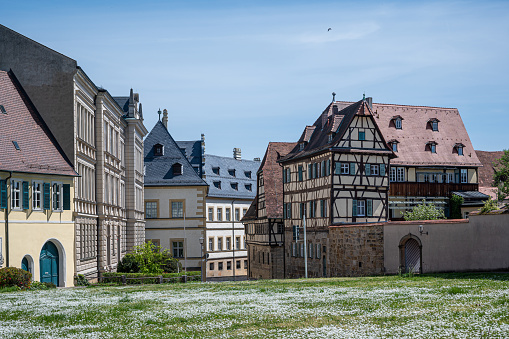Green meadow in front of timber framing houses in Bamberg, Germany