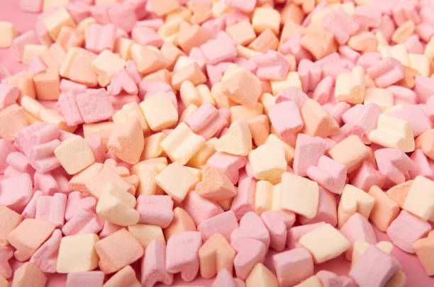 istock Fruit marshmallows in bulk on a pink background.Sweets and snacks for a snack.Chewy candy close-up.Space for copy.Place for text. 1495582129
