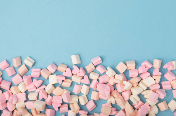 istock Loose fruit marshmallows on a blue background.Sweets and snacks for a snack.Chewy candy close-up.Copy space.Place for text. 1495582145
