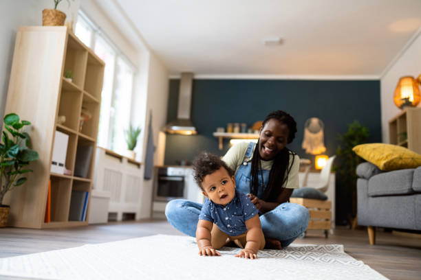 istock Mom and baby son playing at home 1495584576