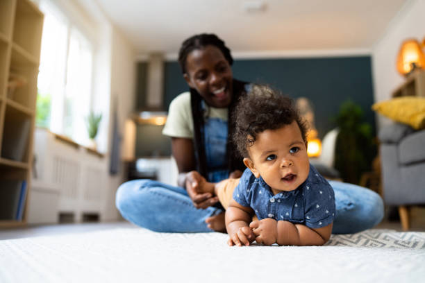 istock Mom and baby son playing at home 1495584578