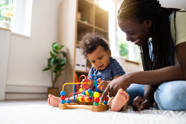 istock Mom and baby son playing at home 1495584682