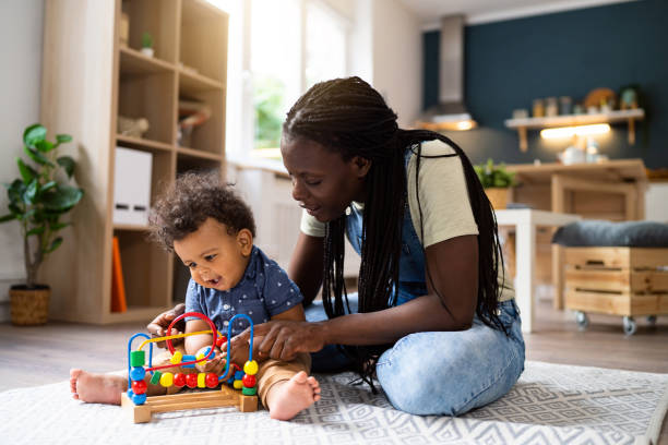 istock Mom and baby son playing at home 1495584694