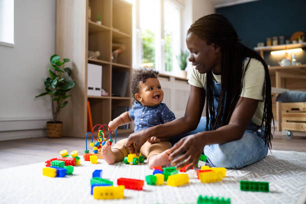istock Mom and baby son playing at home 1495584744