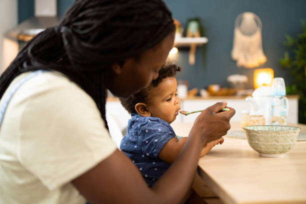 istock Mother feeding her baby boy 1495585647