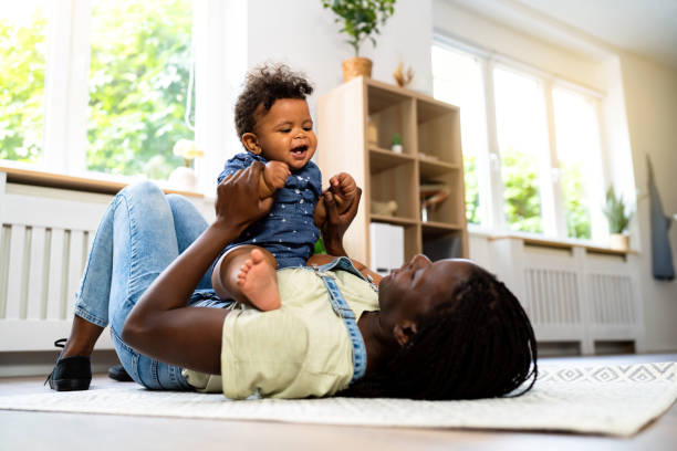istock Mom and baby son playing at home 1495587668