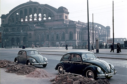 Berlin, Germany, 1957. The war-damaged Anhalter Bahnhof on Stresemannstrasse in Berlin Mitte. Also: pedestrians and parked cars.