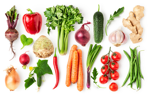 A variety of fresh vegetables on a wooden board.