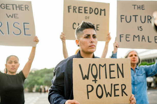 istock Women protesting with placards on street 1495596417