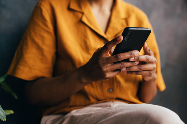 istock An Unrecognizable Businesswoman Texting On Her Mobile Phone 1495599742
