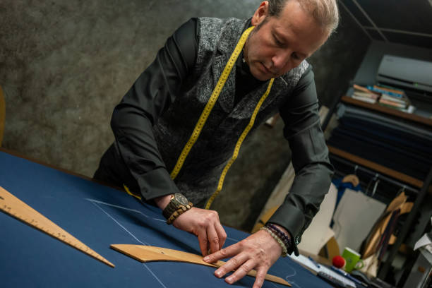 istock men fashion designer is drawing with miter and soap on cloth fabric in studio horizontal still 1495603267