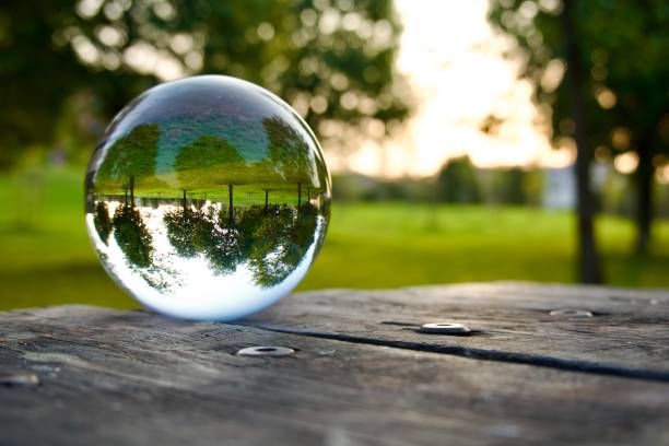 istock Crystal ball on wooden table at park 1495603626