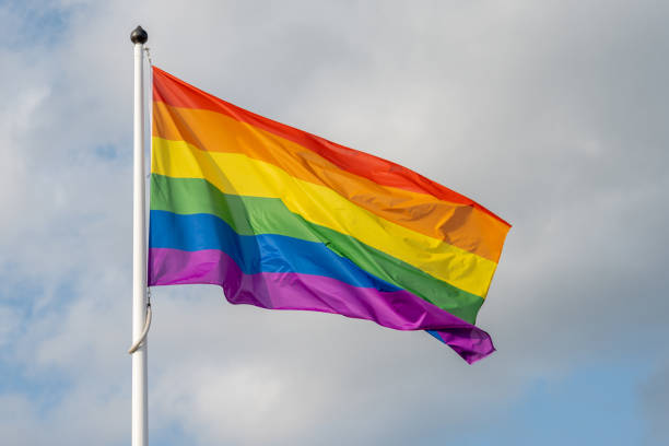 istock Rainbow Flag. LGBTQ+ flag. Diversity and Pride Flag. Rainbow flag on the blue sky background. 1495604992