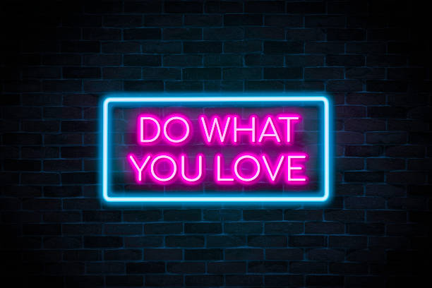 istock Do what you love neon on brick wall background. 1495605345