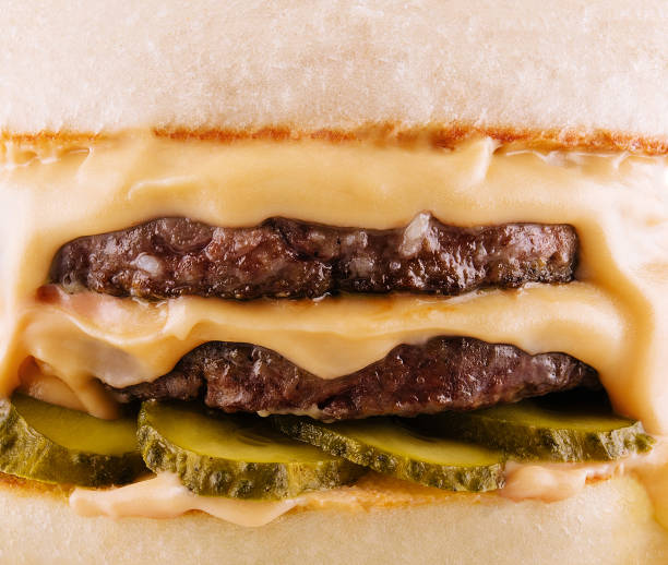 istock hamburger with two cutlets, pickled cucumbers and melted cheese 1495606305