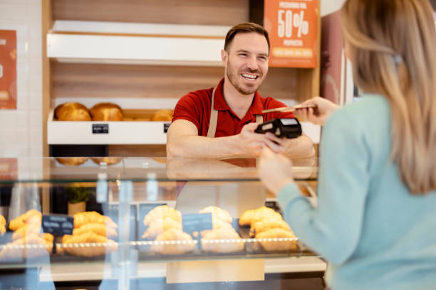 istock Paying With Smartphone at a Bakery Shop 1495606382