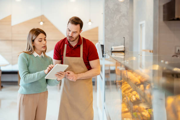istock Female Store Owner and Bakery Worker Talking 1495607007