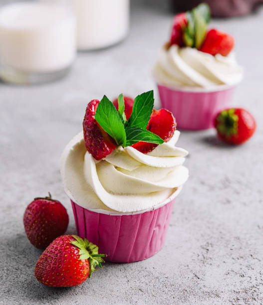 istock Vanilla cupcake with white cream and strawberries 1495609585