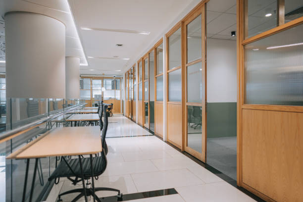 istock open plan co sharing office desk and office chair in a row corridor 1495610148