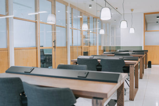 istock open plan co sharing office desk and office chair in a row 1495610151