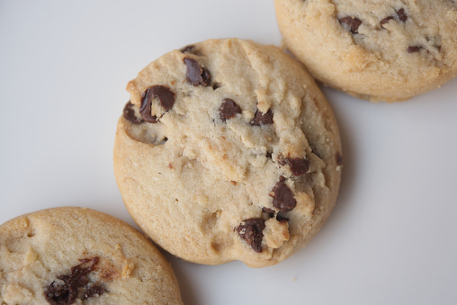 Shortbread cookies with multi-colored chocolate droplets on the white background