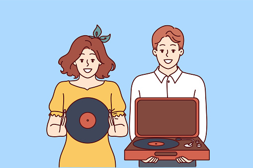 Happy couple with turntable and vinyl record invites you to retro party with jazz music. Young man and woman collecting vintage vinyl records with music from their favorite artists.