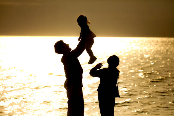 Parents and children playing on the beach