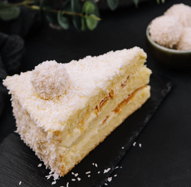 istock Coconut layered, raffaello cake on black tray 1495615181