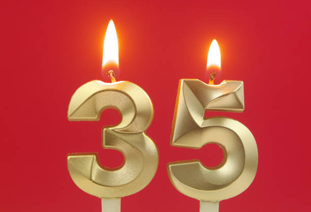 istock Birthday candles on red background, number 35 1495619104