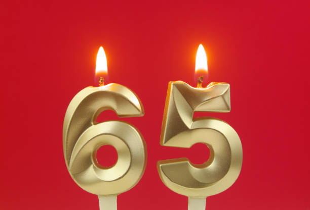 istock Birthday candles on red background, number 65 1495619112