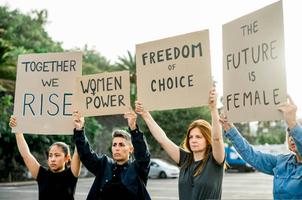 istock Serious female protesters with placards 1495619222