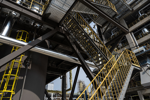 Yellow staircase for equipment in the chemical factory under construction
