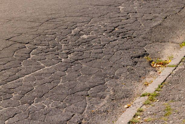 istock Damaged asphalt pavement , close up 1495623074