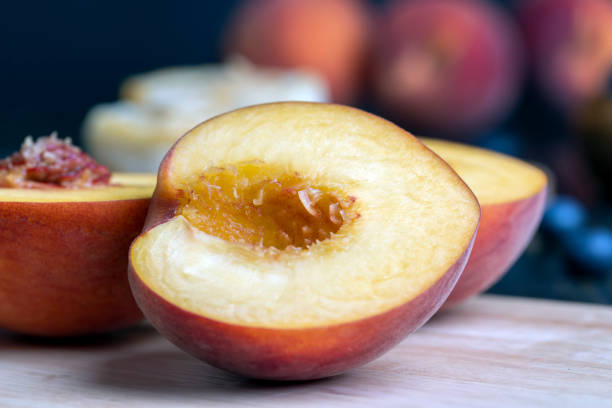 istock Ripe fresh peaches on a wooden table 1495623273