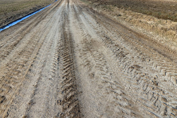 istock a broken country road at the beginning of spring 1495624162