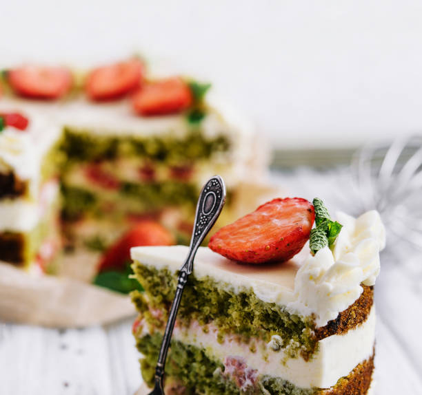 istock Green pistachio cake with strawberries closeup 1495624366
