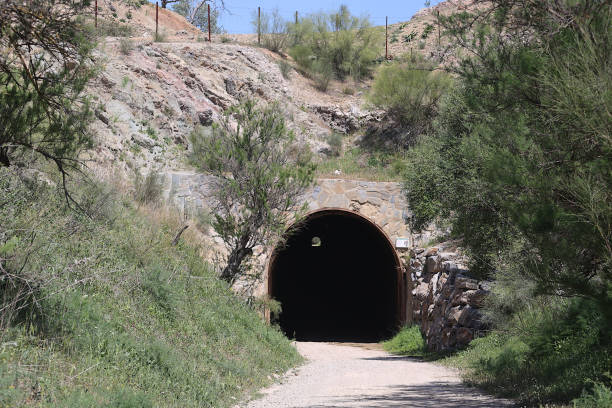 Via Verde Bicycle Trail - Andalusia, Spain The Via Verde trail is a beautiful route through sections of Andalusia, Spain. It is a multi-use trail, often travelled on foot or on bicycle. The section of the train near Olvera has a very large number of tunnels, some illuminated, others not. This trail was created on an old rail link that was never even travelled by trains because work was interrupted by the civil war. This view shows the entrance of a rather short tunnel. via verde spain stock pictures, royalty-free photos & images