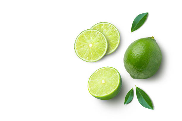 istock lime with half sliced and green leaves isolated on white 1495626702