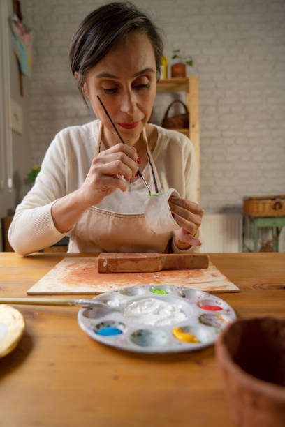 istock Woman painting a pottery 1495635578