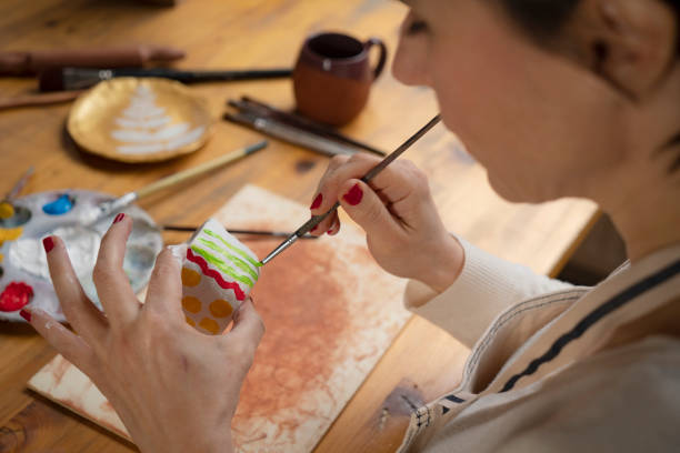 istock Woman painting a pottery 1495636048