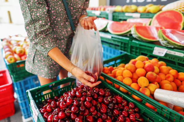 istock closeup hand picking sour cherry at market 1495636700