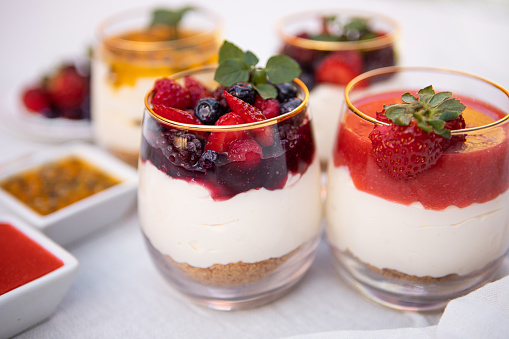 Delicious passion fruit cheescake, strawberry and red fruits berries cheescake served in a glass cup - Argentine culture - Buenos Aires - Argentina