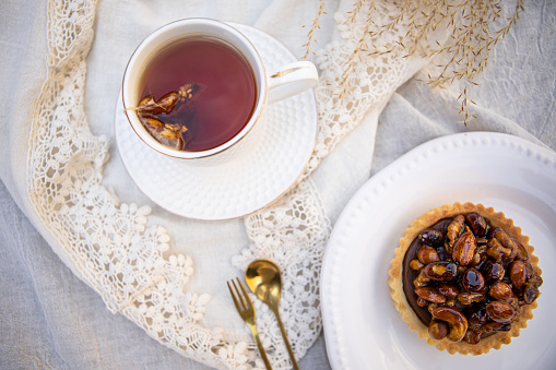 Delicious dulce de leche and caramelized dried fruits pie with tea - Argentine culture - Buenos Aires - Argentina