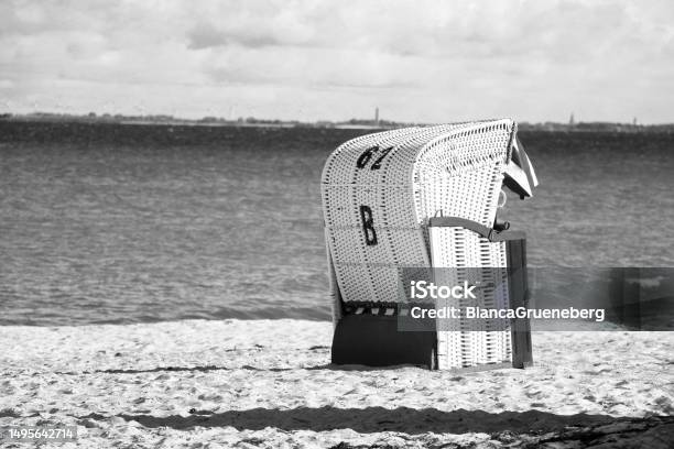 A Black And White Closeup Of A Beach Chair On The Beach Stock Photo - Download Image Now
