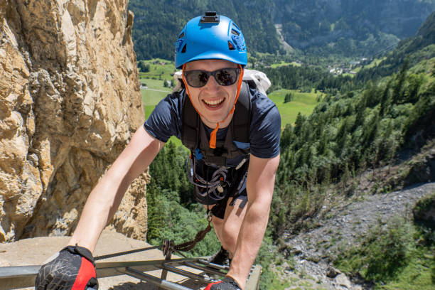 istock High angle view, man on Via Ferrata climbing up a ladder 1495644639