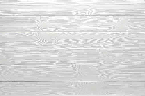 White wood table background, top view. Textured painted floor, board texture, wooden siding. Light gray horizontal planks, grey empty slats. Timber panel surface. Natural materials