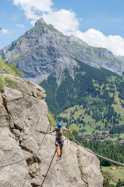 istock Man on Via Ferrata crossing on a suspension bridge 1495646361