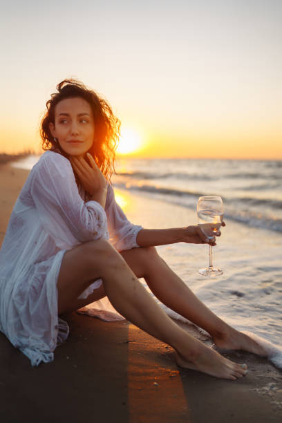 istock Beautiful woman  walking at a beach at sunset. 1495648079