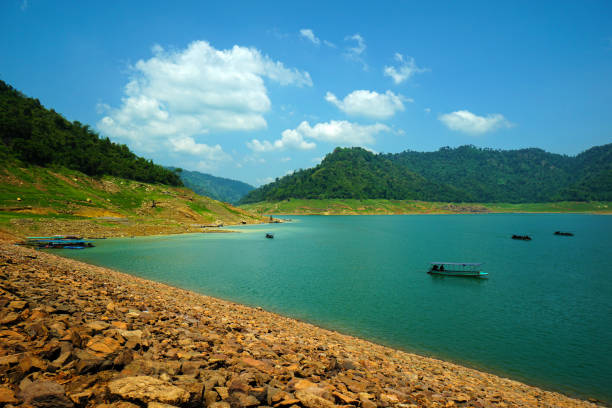 istock Upstream view on the dam's crest with a long-tailed boat. 1495648814